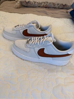 Nike White Low-Top Sneakers with Brown Swoosh